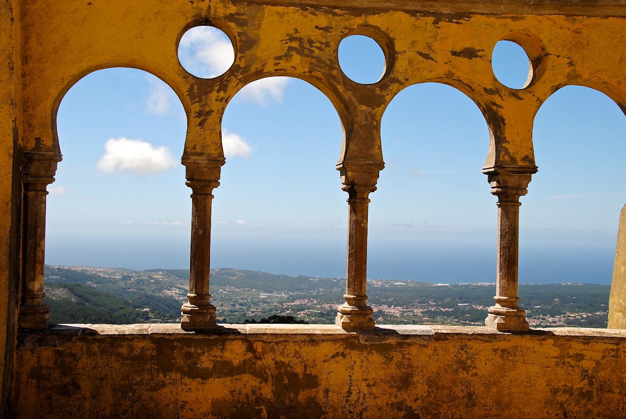Gorgeous ocean view through vintage arches at Sintra Palace, Portugal.