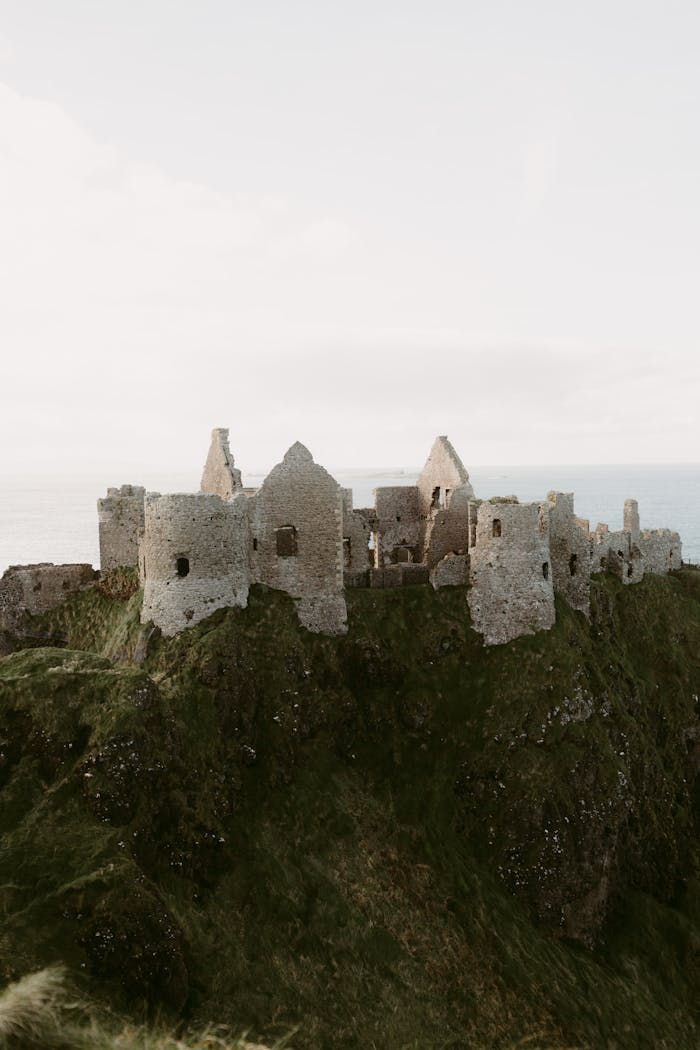 Explore the iconic ruins of Dunluce Castle perched on the dramatic cliffs of Northern Ireland.